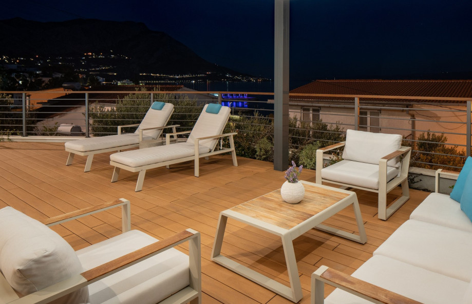 4 deck chairs, outdoor shower,  covered and comfortable lounge corner and all with spectacular sea views