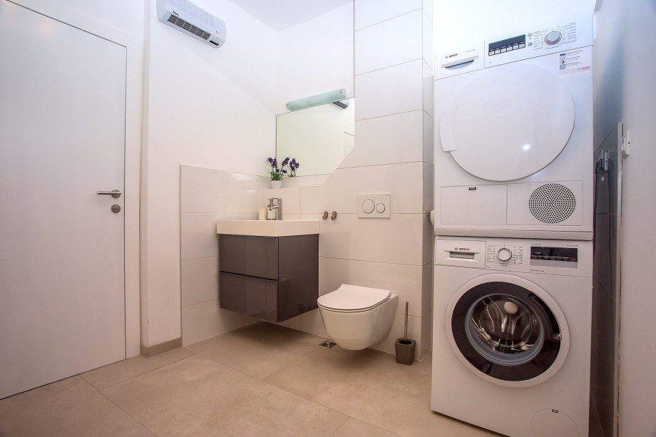 A separate toilet with laundry and all needed amenities on the ground floor