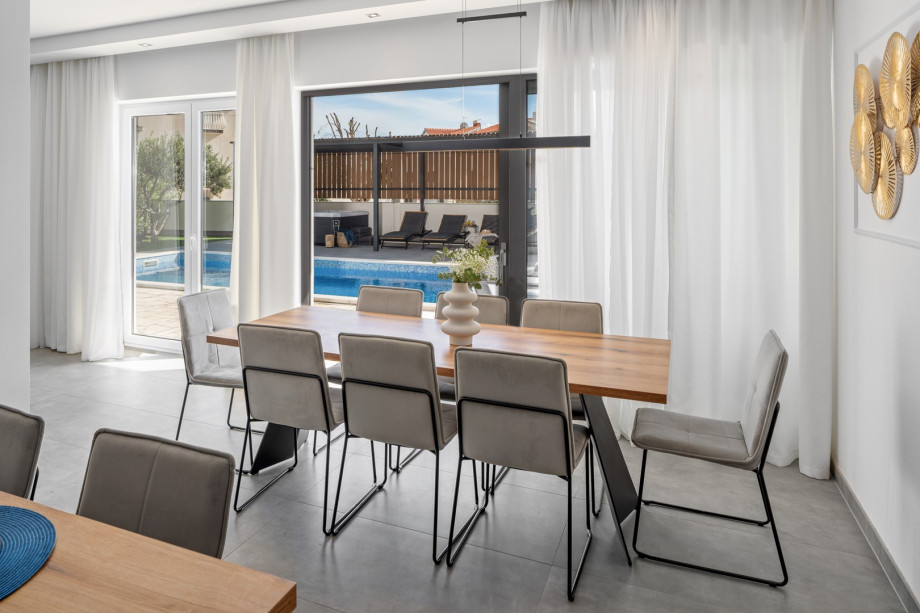 The ground floor floor (pool level) offers a fully air-conditioned, open-plan living and dining area