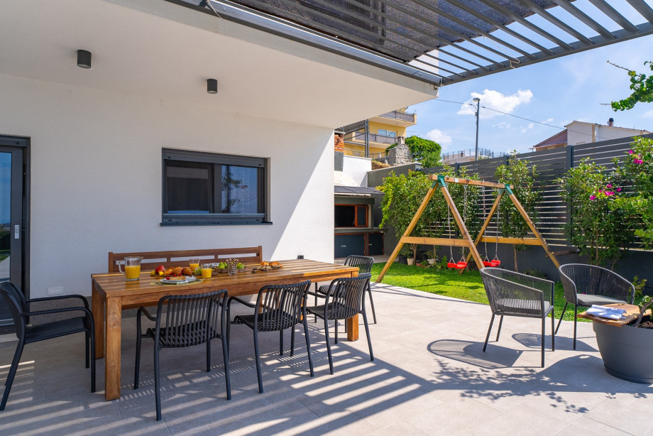 The outdoors offers a covered dining area for 10 people.
