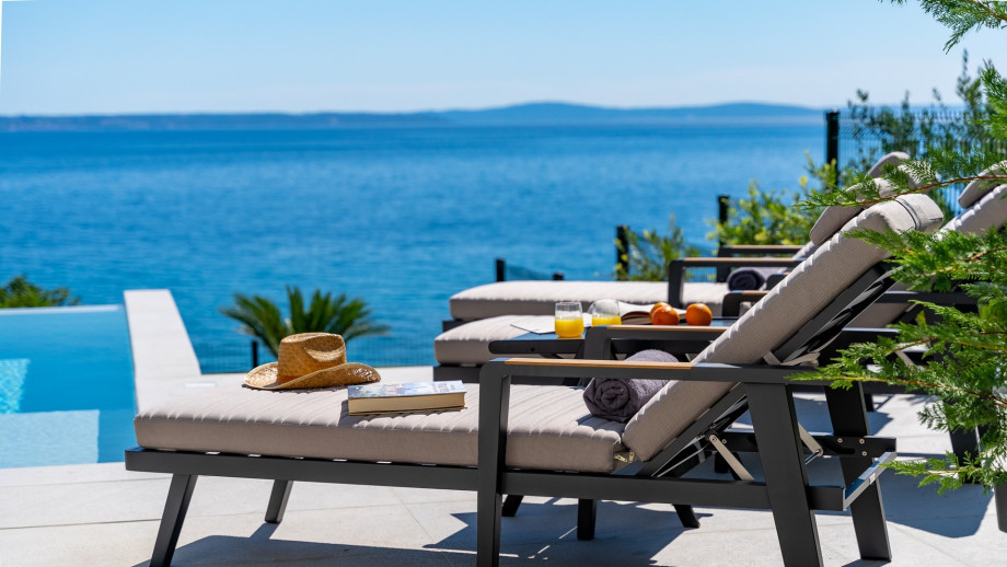 Comfortable sun deck area around the infinity pool with very comfortable sun-deck chairs