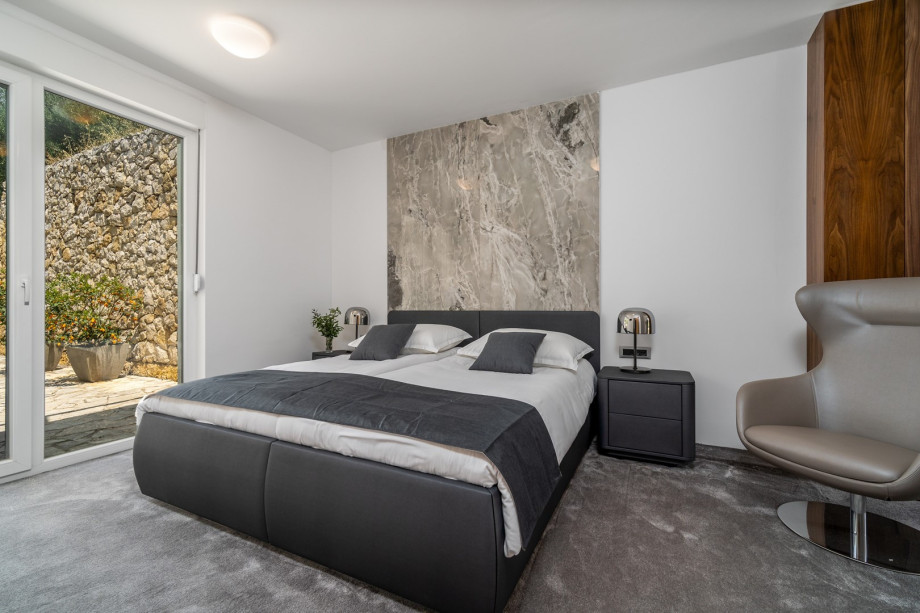 Bedroom No1 with two single beds 90cm x 200cm that can connect into a king size, flat screen TV and exit toward the outdoor dining area