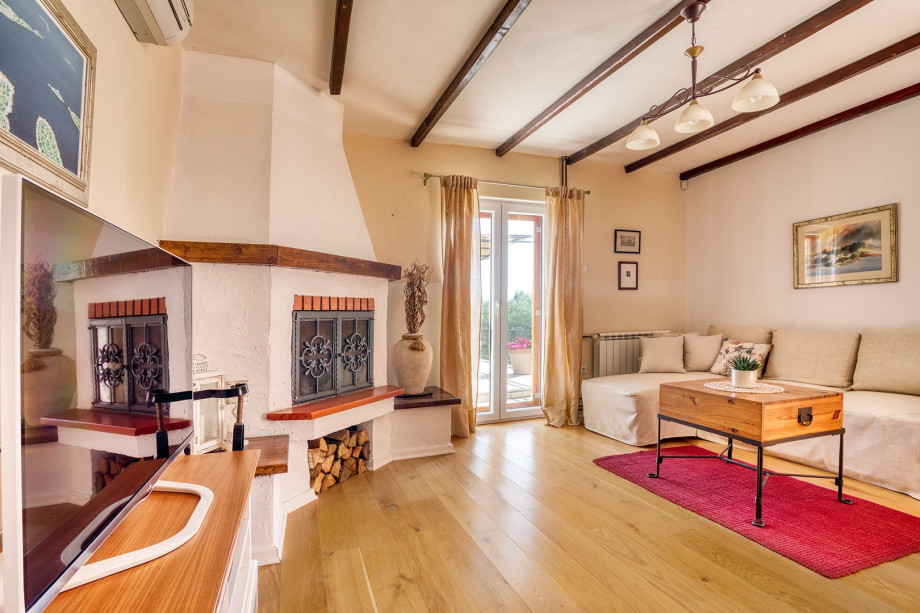 A living room offers exit to outdoor dining area