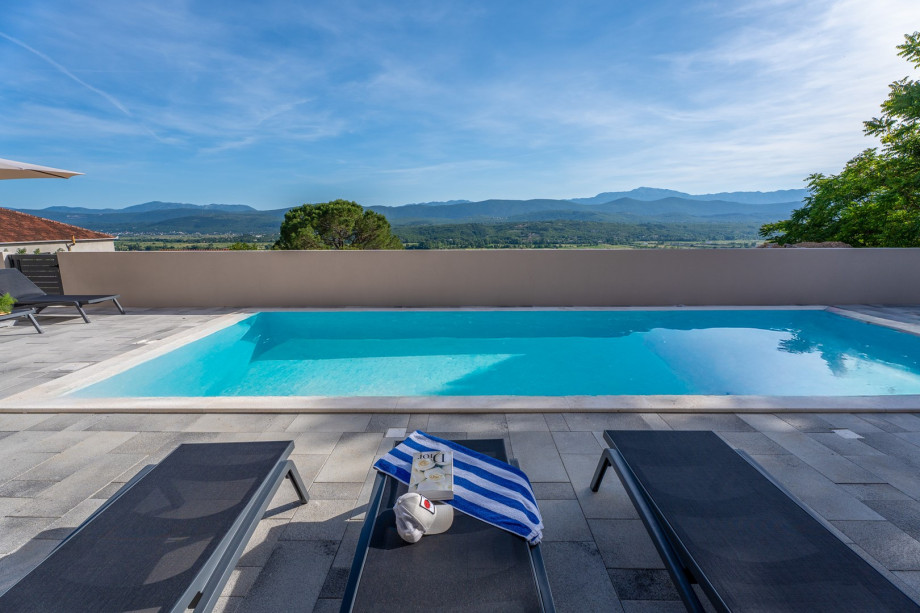Sun terrace with 9 comfortable sun loungers and a beautiful view of the landscape