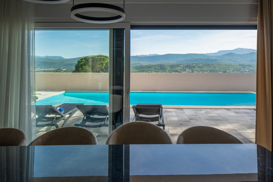 A comfortable dining table perfect for enjoying homemade meals together overlooking the pool and sundeck