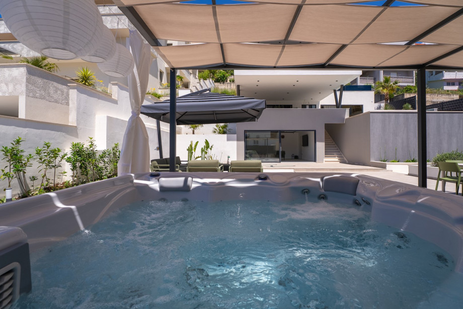 Step outside to discover your personal outdoor oasis, complete with a luxurious Whirlpool (a Hot tub)