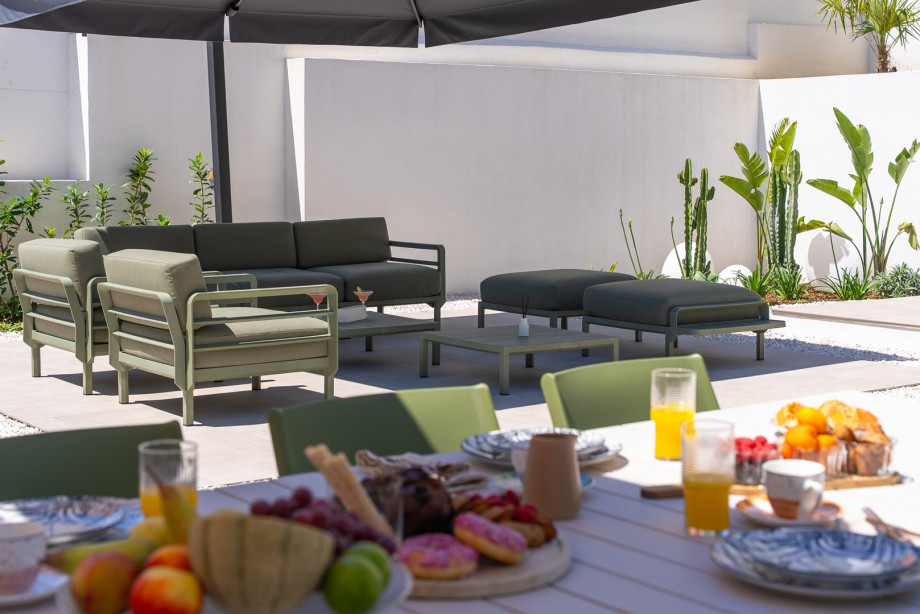 Covered outdoor dining space for up to 10 guests.