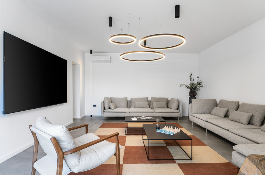 Spacious living room adorned with  massive flat-screen TV