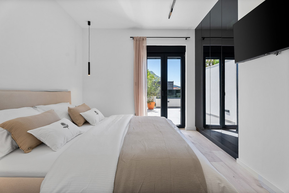 The bedroom features a flat-screen TV with Netflix and HBO.