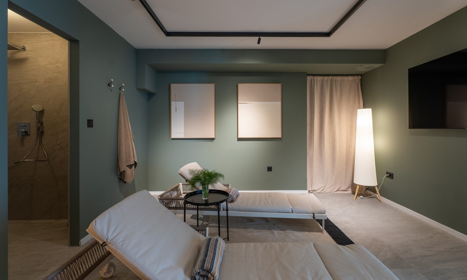 Begin your journey of relaxation on the ground floor, featuring a sauna and lounge chairs for ultimate comfort.