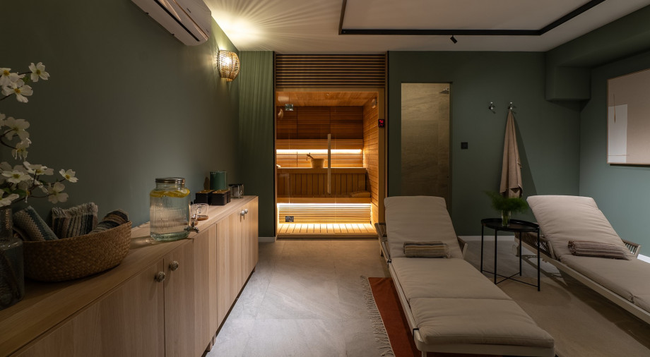 Unwind on the ground floor in the soothing sauna area, complete with comfortable lounge chairs.