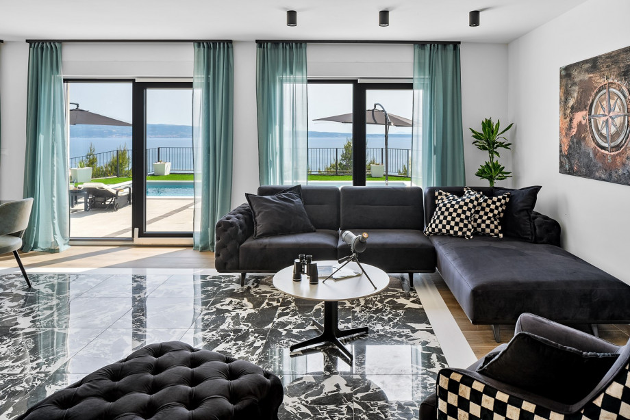 filled with natural light thanks to large glass doors that open directly onto the pool terrace.