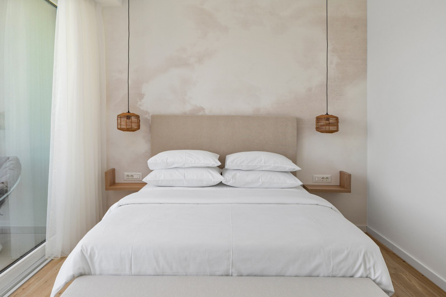 Bedroom No2 also offers an A/C, a TV, and a balcony with pool views