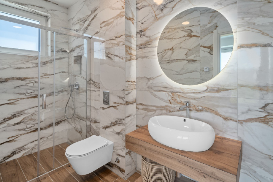 An en-suite bathroom with a shower, a sink, and a toilet