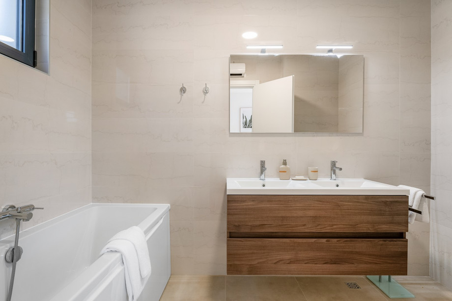 En suite bathroom with bathtub and a shower.