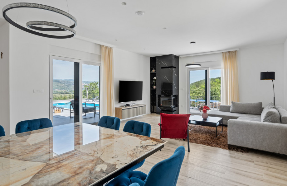 As you step inside, you are greeted by a seamless open-plan living, dining, and fully equipped kitchen area with a kitchen island