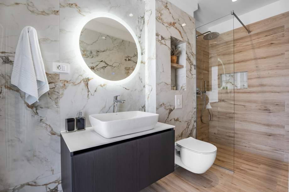 An en-suite bathroom with a shower, a sink, and a toilet