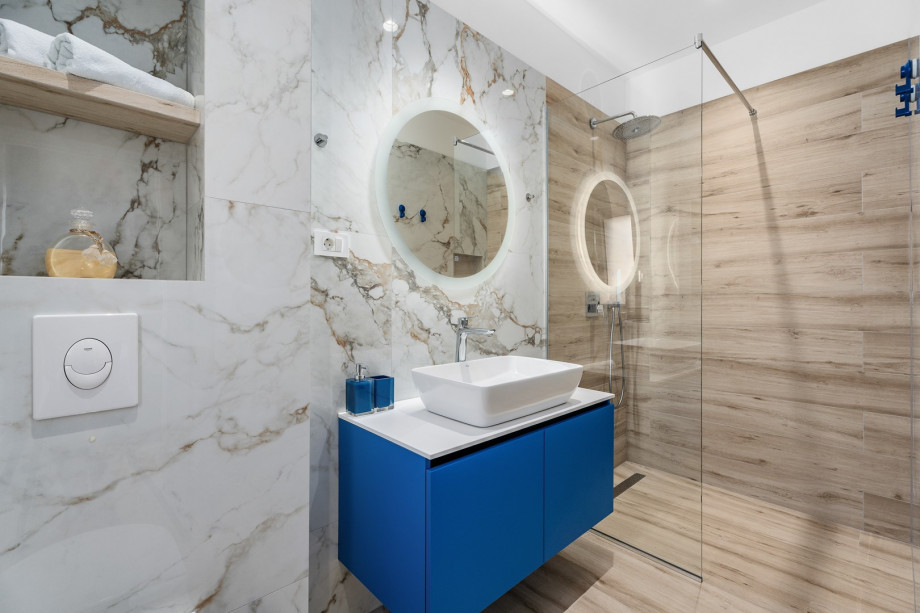 An en-suite bathroom with a shower, a sink, and a toilet