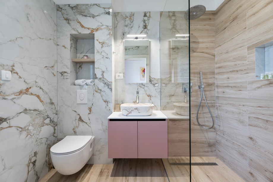 An en-suite bathroom with a shower, a sink, and a toilet