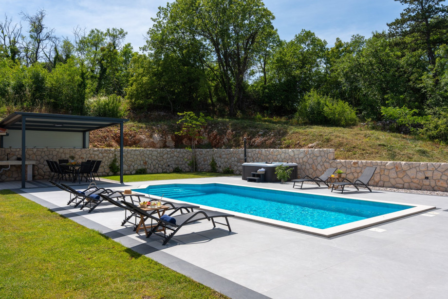A relaxing area by the pool with a panoramic view