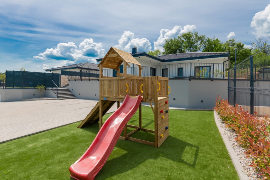 The property is family-friendly, featuring a Playhouse with a slide and swing for children