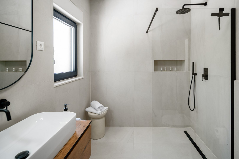 Family bathroom with shower and laundry facilities (washing machine, dryer, ironing amenities)