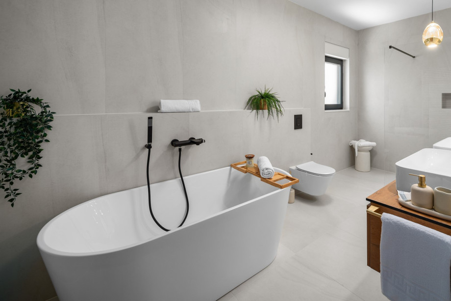 Spacious family bathroom with bathtub, shower, and dual sinks