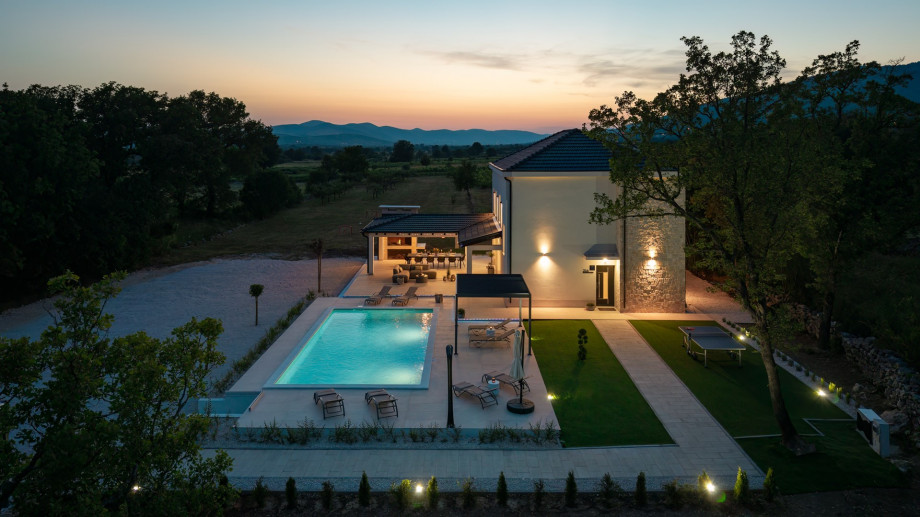 The tranquil surroundings effortlessly blend indoor and outdoor living, allowing for seamless gatherings and unforgettable moments