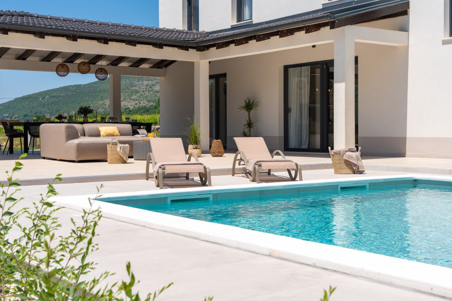 A sun deck with comfortable loungers and umbrellas for shade and rest