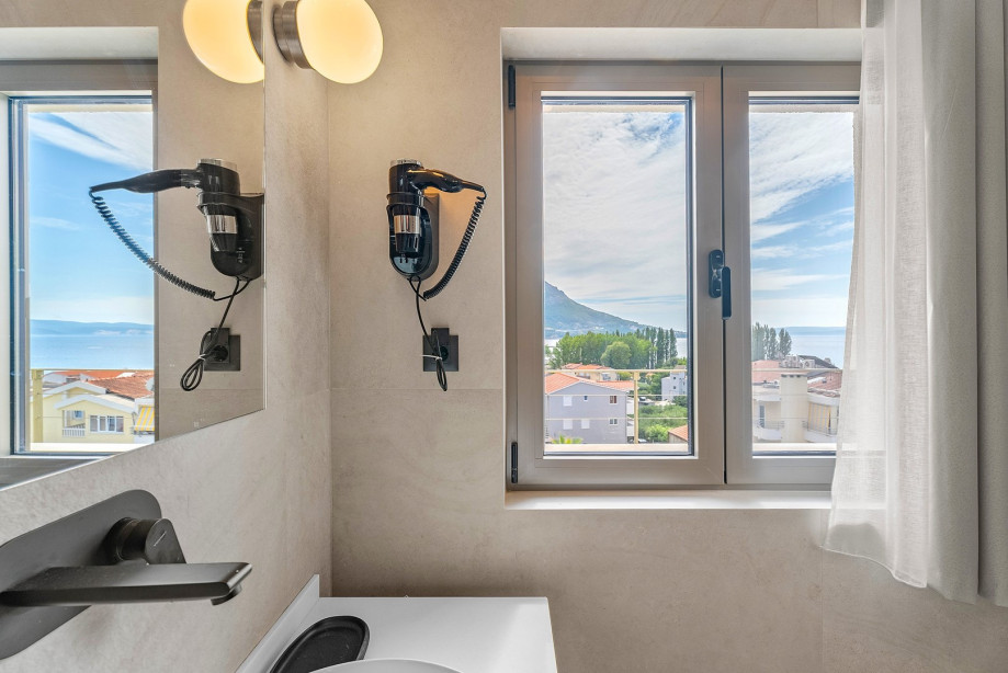 An en-suite bathroom with a shower, a sink, and a toilet
