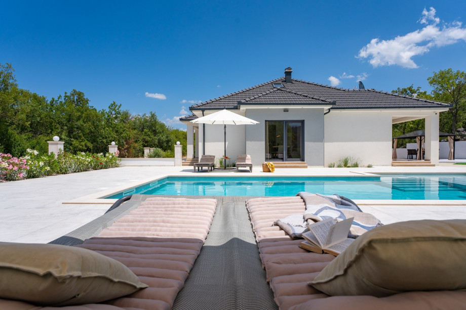 Sun deck with 6 comfortable loungers and 2 umbrellas for lazy afternoons in the sun