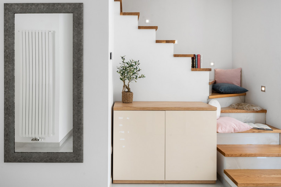 A cozy reading nook tucked into the staircase landing — the perfect spot to unwind with a good book.