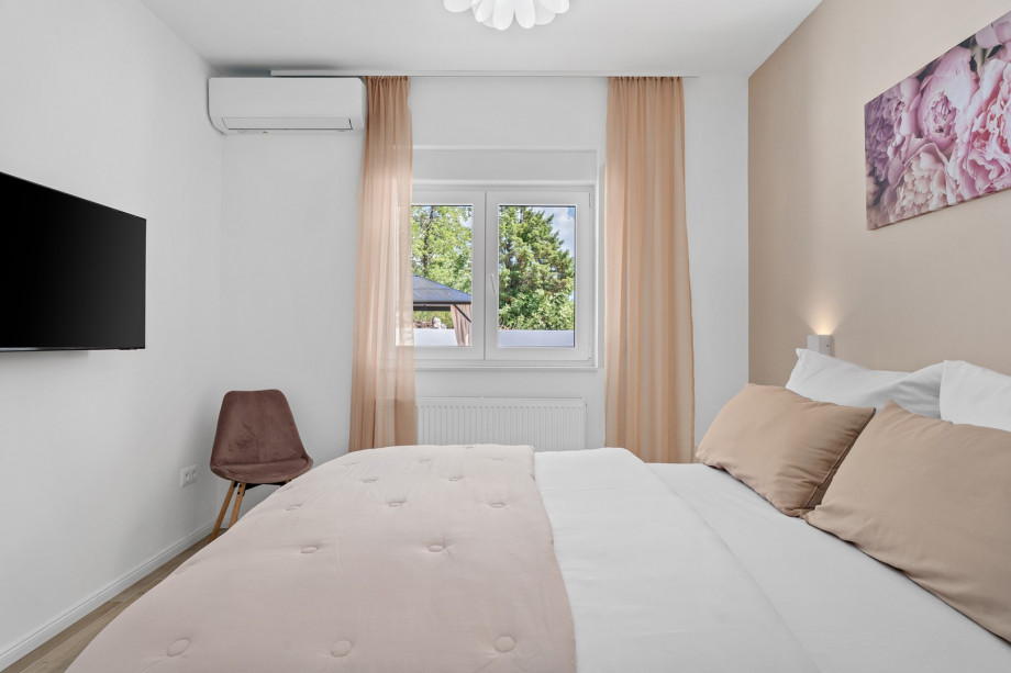 TV, air-conditioning, and views toward the outdoor dining area