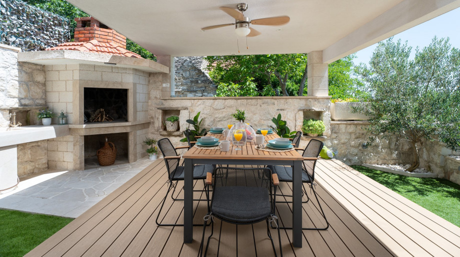 Outdoor dining area with a traditional barbecue