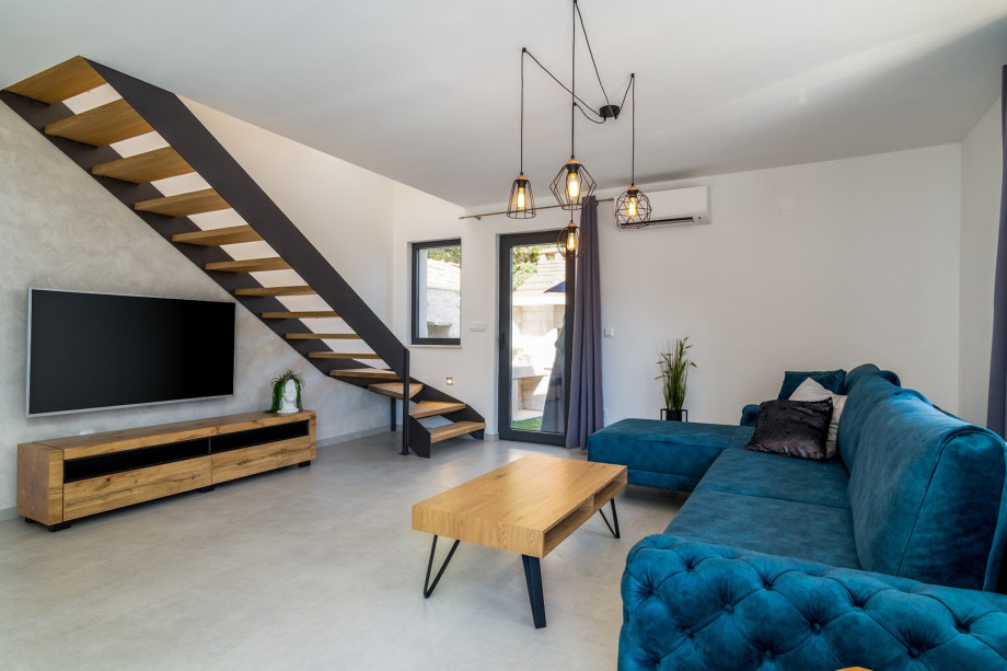 There is also a living room with sofa, A/C, flat-screen TV, PS4