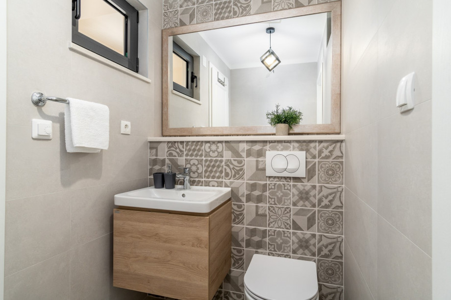 There is also a separate toilet and a laundry with a washing machine and a dryer