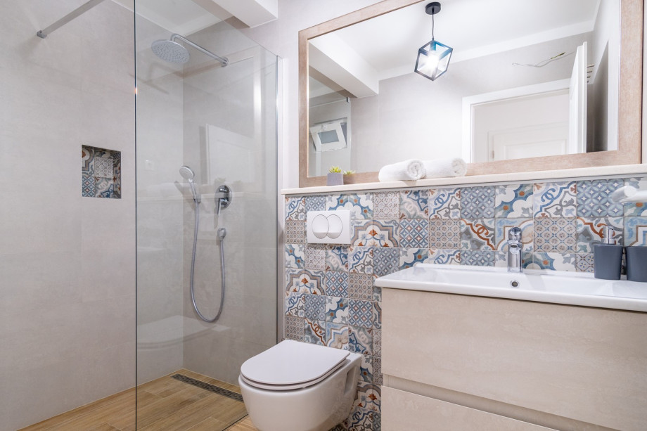 An en-suite bathroom with a shower, a sink, and a toilet