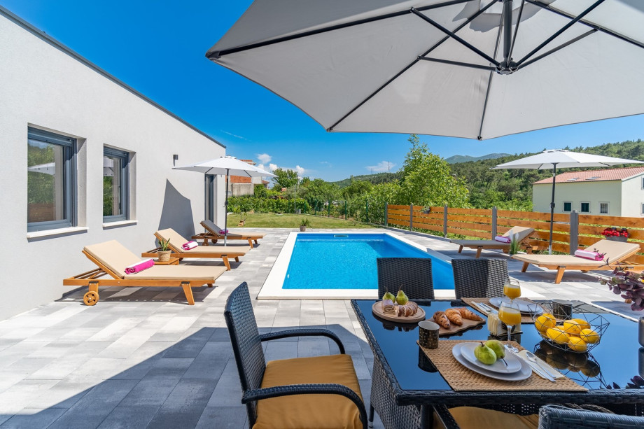 Private swimming pool with 6 deck chairs, outdoor dinning area with BBQ