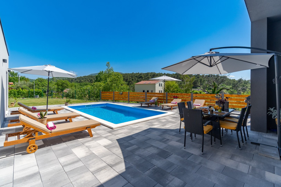 Private swimming pool with 6 deck chairs, outdoor dinning area with BBQ