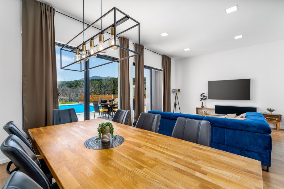 Dinning and living area with sliding glass doors toward the pool area