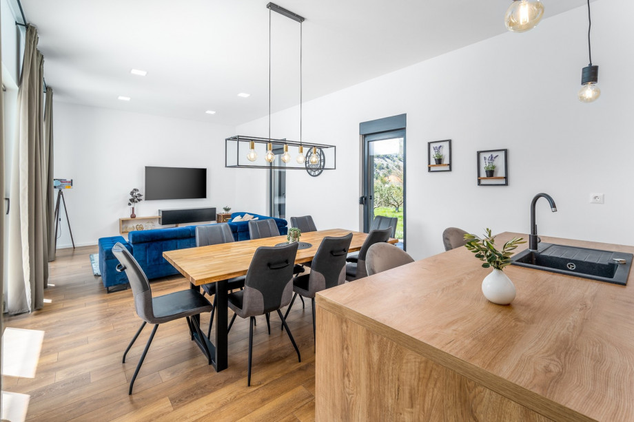 Dinning and living area with sliding glass doors toward the pool area