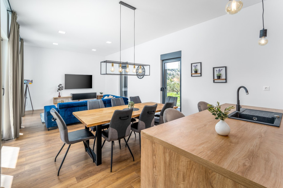 Dinning and living area with sliding glass doors toward the pool area