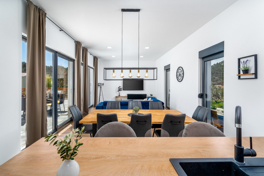 Dinning and living area with sliding glass doors toward the pool area