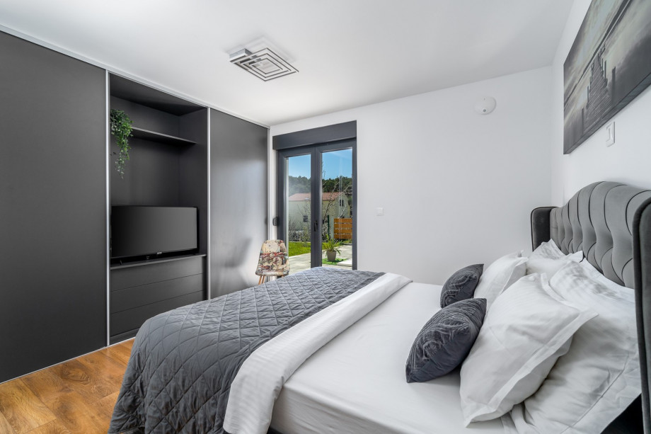 Bedroom No1 with king size bed 180cm x 200cm, en-suite bathroom with shower, a TV, Air-condition and exit toward pool area