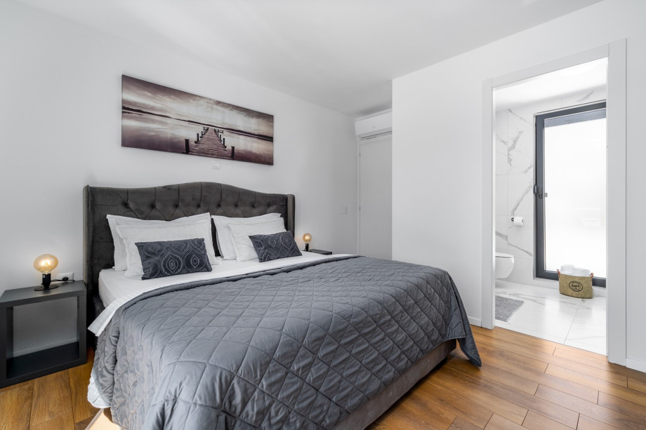 Bedroom No1 with king size bed 180cm x 200cm, en-suite bathroom with shower, a TV, Air-condition and exit toward pool area