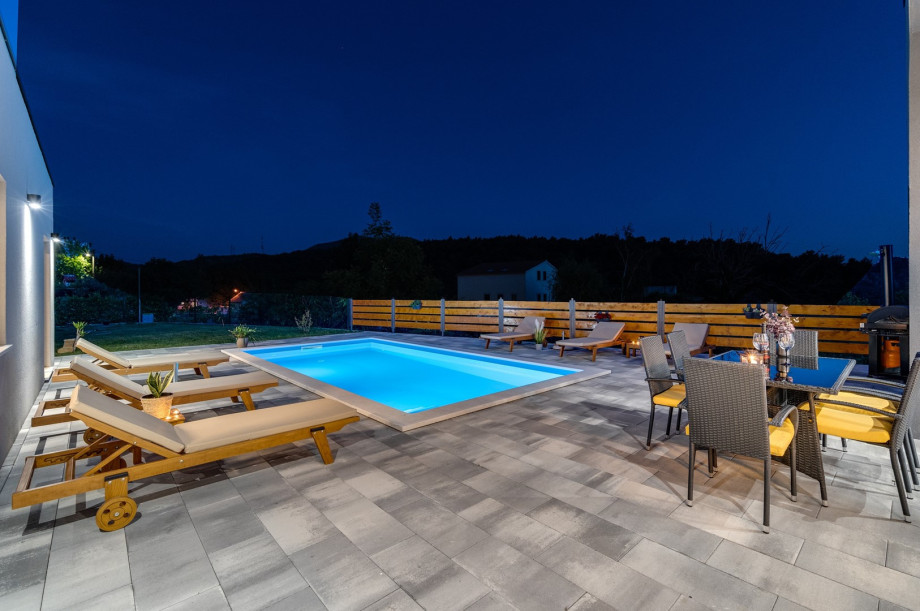 Private swimming pool with 6 deck chairs, outdoor dinning area with BBQ