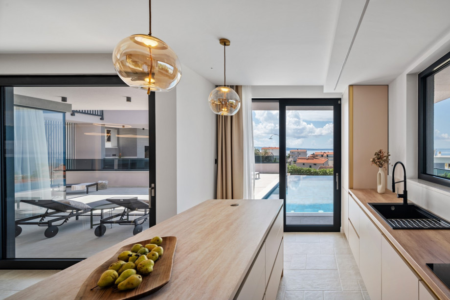 A kitchen is equipped with a modern kitchen island
