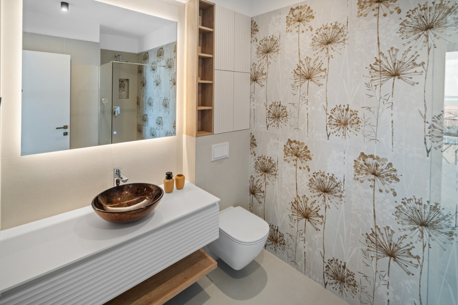 An en-suite bathroom with a shower, a sink, and a toilet