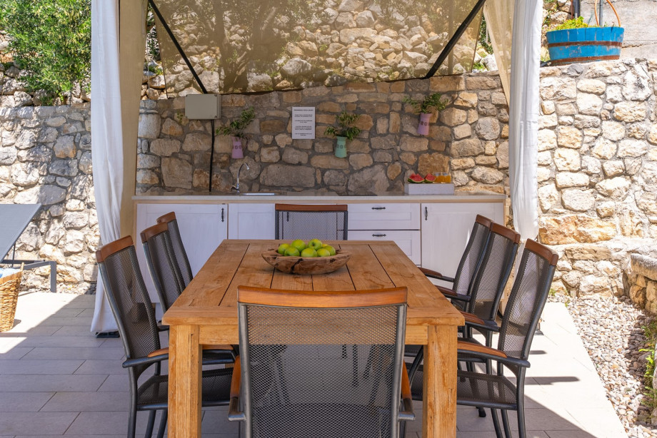 Outdoor kitchen and dining table at the pool area.
