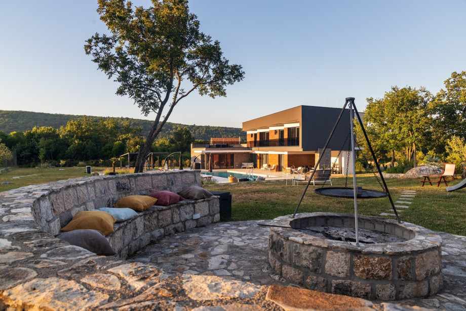 Relax by the fire pit during the day — a charming spot to unwind, enjoy a cup of coffee, or soak in the peaceful surroundings of the villa.